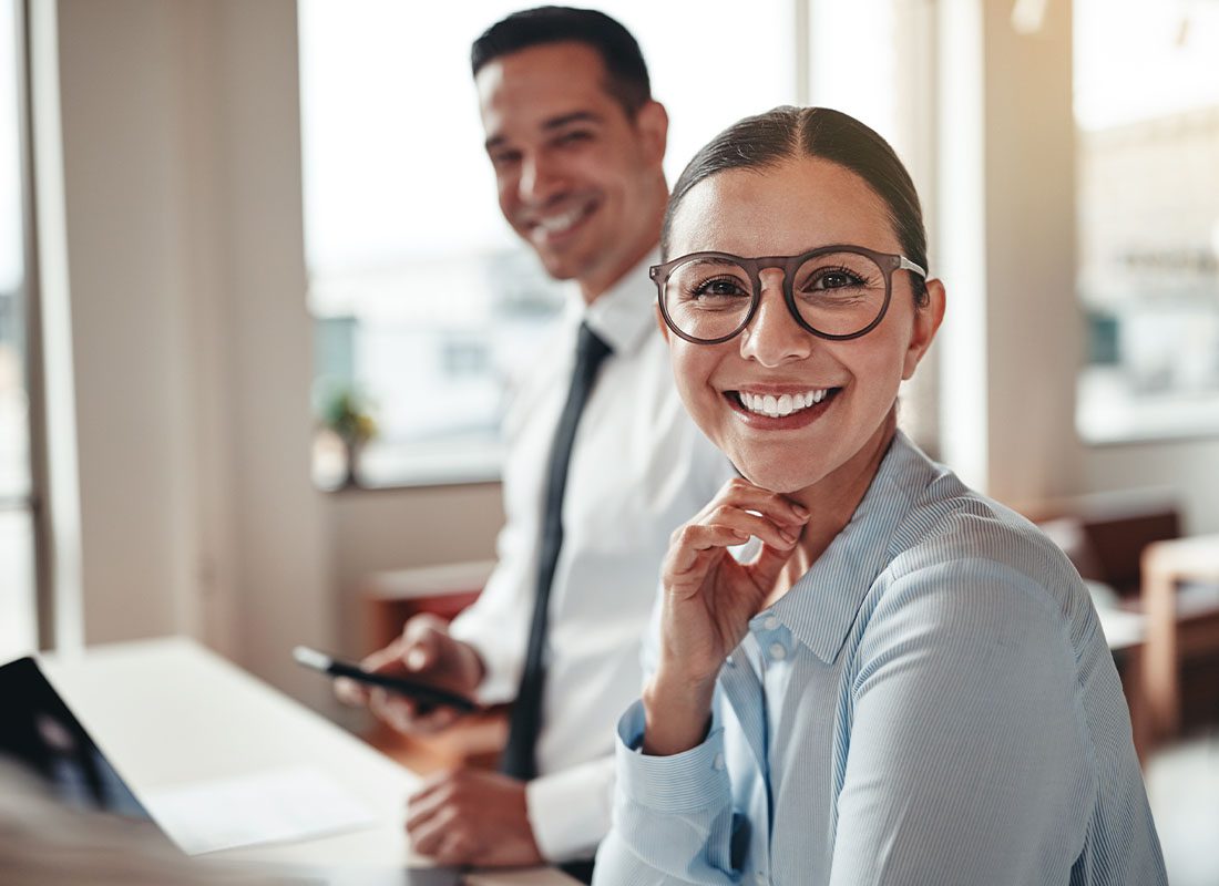 Contact - Portrait of Smiling Business Woman in a Modern Office