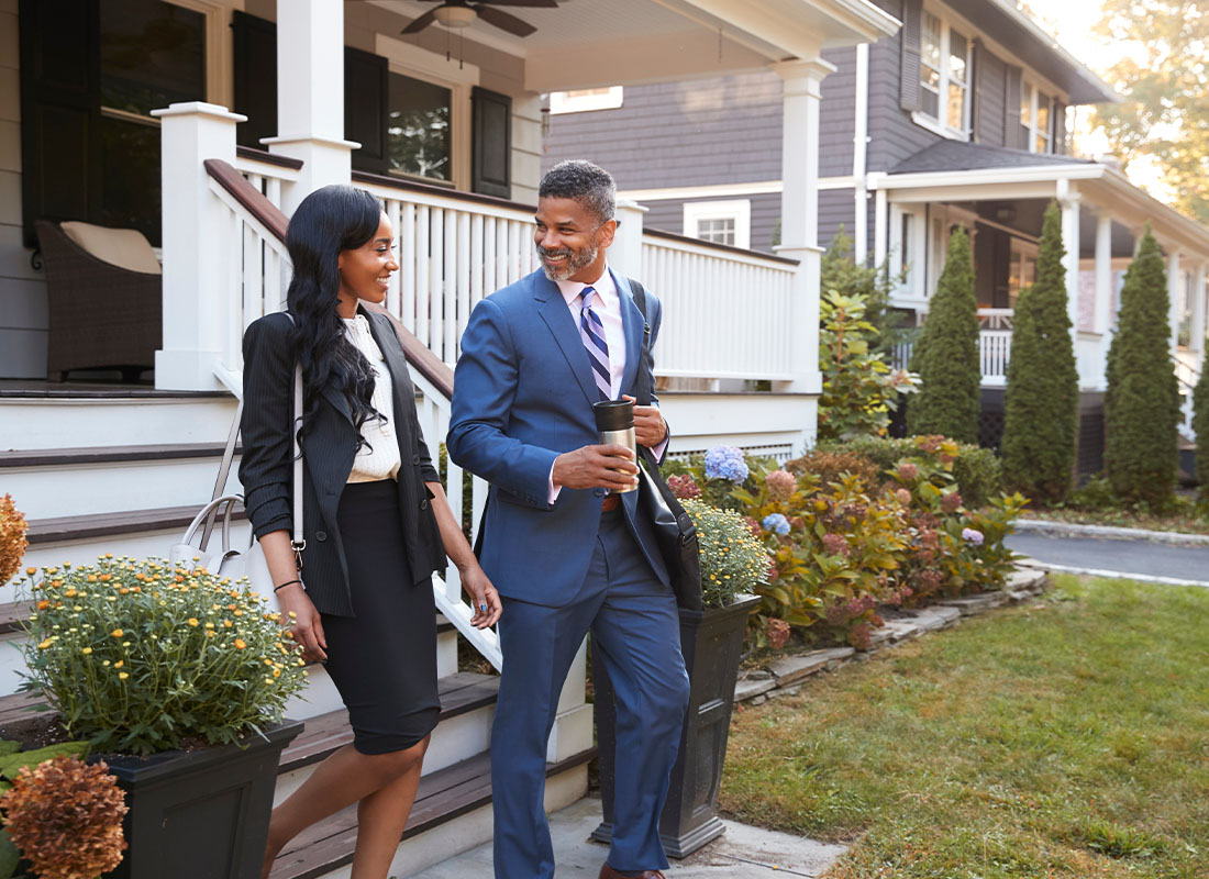 Insurance Solutions - Business Couple Leaving Suburban House for Commute to Work